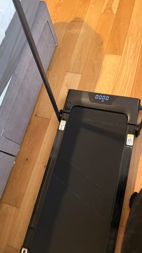 Customer's Umay U18F Walking Pad set up on a wooden floor with the handlebar raised.